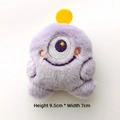 Detail view of a purple plush monster charm with embroidery measuring 9.5cm by 7cm - Purple
