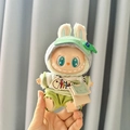 Labubu plush doll wearing green hooded sweatshirt and grey knit hat with fishbone embroidery - Fish Pendant Crossbody Bag Set / First And Second Generation Keychains Are Compatible With La Cloth Dolls. Dolls Not Included.