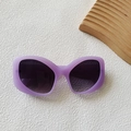 Lavender matte cat-eye sunglasses with dark grey lenses on white textured background - Purple