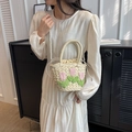 Stroh-Eimertasche in Beige mit Tulpen und Perlenriemen am Model präsentiert - Cremeweiß