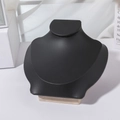 Detail of minimalist necklace display stand with black matte finish and wooden base - Black Leather