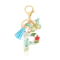 Letter P resin keychain with red dried flowers, blue tassel and golden butterfly charm - Letter P