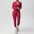 Detail of high-waist yoga leggings featuring functional side pockets in dark rose red - Carmine