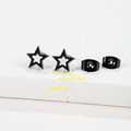 Detail view of 0.8cm black hollow star stud earrings with butterfly backs on stone - 008 Black Hollow Star