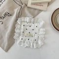 Close-up of white fabric coaster with black heart patterns and delicate lace edges - Black Mini Coaster