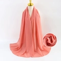 Elegant solid peach orange pearl chiffon scarf displayed on a minimalist mannequin - Sunstone