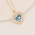 Close-up of golden heart pendant with a blue eye inlay and white cubic zirconia accents - Bright Blue Round Eye (8#)