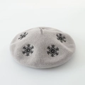 Detailed view of grey wool felt beret with black snowflake embroidery on a white background - M (56-58cm) / Snowflake Grey