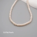 Minimalist freshwater pearl necklace featuring 5.0mm flat cream pearls on grey background - Flat Bead