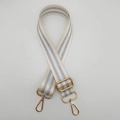 Detail view of cream canvas bag strap with silver glitter stripes and gold hardware - Cream White + Gold Hook