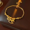 Double-layered gold bracelet with lucky coin and rocking horse charms on leather - Bracelet - Gold Pony (Real Gold Plated)