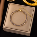 Close-up of gold stainless steel bracelet with purple square zircons and K18 hallmark - Gold with Grey-Purple Zirconia
