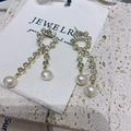 Elegant gold drop earrings with tassel zircon chains and freshwater pearl accents - Cross Pavé Zircon Tassel Pearl Stud