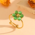 Detail of gold floral ring with green cat eye stones and smooth polished metal finish - Gold Green Cat's Eye Ring
