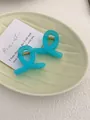 Detail of two light blue resin shark hair clips with golden springs on a light background - Mini Butterfly Clip X-Shaped (Approx. 4cm) / Translucent Blue Green