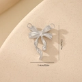 Macro detail of silver bow pendant with dimensions 2.5cm by 1.4cm for jewelry making - Brushed Metal Style MYYX00630 / Silver