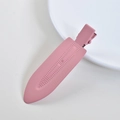 Macro shot of pink matte hair clip with dotted texture and embossed text detail - 20# Metal 7cm Pink No-Trace Clip