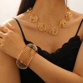 Retro wide golden spiral bangle and ball chain necklace set on model with black dress - Gold (KC Gold Necklace + Bracelet)
