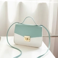 Small mint green and white color-block crossbody bag with gold-tone twist lock and top handle - Blue