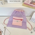 Close-up of purple mesh drawstring backpack featuring a pink front zipper pocket - Light Purple