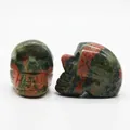 Natural Unakite gemstone skull carving showing unique green and pink floral texture - Unakite