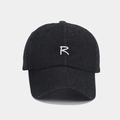 Detailed texture of black denim baseball cap featuring a white embroidered letter R logo - Adjustable / Black