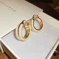 Detail of 18k gold plated hoop earrings with white inlay inside a white gift box - Gold/White Hoop