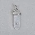 Macro shot of a hexagonal natural clear quartz crystal pendant with a silver metal clasp - White Crystal