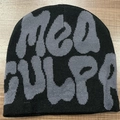Flat lay of Mea Culpa knit beanie with grey lettering on wood background - One Size / Black