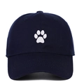 Detail view of white paw print embroidery on a navy blue cotton twill baseball cap - One Size / Navy Blue