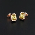 Macro shot of rose gold rectangle stud earrings with yellow step-cut zircon stones - Rose Gold Plated Yellow Zirconia