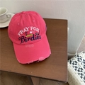 Distressed rose red baseball cap with embroidered lettering on a wooden table - Adjustable / Rose Red