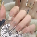 Detail of short French gradient press-on nails with elegant rhinestones and metal charms - Z644 Coconut Gradient / Nail Glue Version