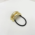 Close-up of golden geometric metal hair tie with black elastic cord for women - Eco-friendly Style C Gold