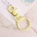 Light yellow alloy lobster clasp with a rotating spring ring on marble background - Light Yellow