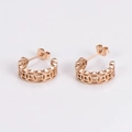 Close-up of rose gold cutout earrings featuring traditional Chinese ancient coin patterns - Rose Gold