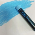 Single vibrant blue oil pastel stick showing creamy texture and pigment on paper - Light Blue