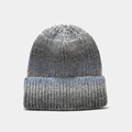 Detailed close-up of the grey-blue melange chunky knit texture on a winter beanie hat - Gray