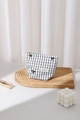 Detail of checkered fabric makeup bag with metal floral zipper pull and logo patch - Small / Black Plaid