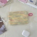 Detail view of colorful knitted plush heart pouch with a pink wrist strap and secure zipper - Yellow Rainbow