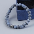 Dark blue agate bead bracelet with cracked patterns and black metallic cylindrical bead - Black Weathered Stone