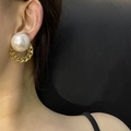 Close-up of oversized freshwater pearl earrings with golden chain links on a model - Large Pearl Gold Metal Chain Hoop