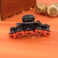 Detail of a whimsical orange pumpkin hair claw with a black wizard hat for Halloween - Wizard Hat Pumpkin Head
