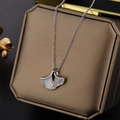 Silver ginkgo leaf necklace with mother of pearl and crystals on a bronze jewelry box - Silver