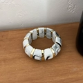 Elastic resin bracelet with black and white marble pattern beads and gold metal spacers - White