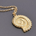 Macro detail of a golden conch shell pendant on a fine stainless steel chain necklace - Necklace Set / Gold