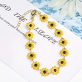 Minimalist golden chain bracelet featuring twelve yellow daisy flowers and adjustable lobster clasp - Large Flower Bracelet / Yellow