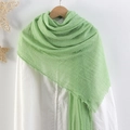 Light green crinkled linen scarf for women with fringe edges on a wooden hanger - Light Green