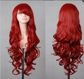 Close-up of long wavy red wig with side-swept bangs showing hair texture and curls - Red