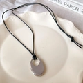 Minimalist silver oval hollow pendant necklace with sleek black cord on a ceramic plate - Hollow Oval Style (14#) / Adjustable / Silver-Circle Oval